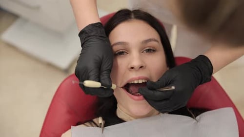 Teenage Girl Having Dental Exam in Clinic