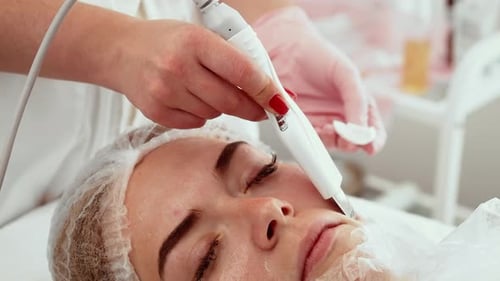 Professional Using Ultrasonic Cleansing Tool During Skincare Treatment in Cosmetology Studio Expert