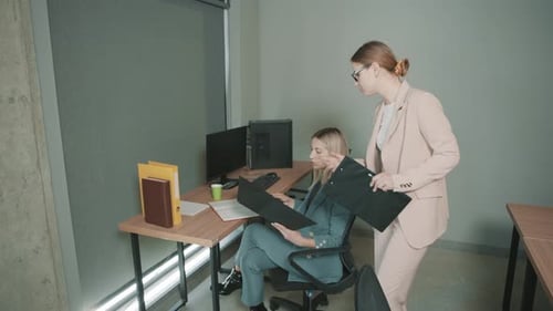 Team members discussing project details in a modern office setting while collaborating