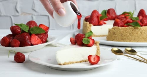 Delicious Cheesecake Slice Topped with Strawberry Syrup