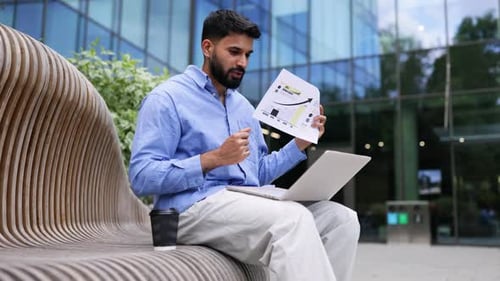 Young Adult Presenting Business Data Outside Office Building