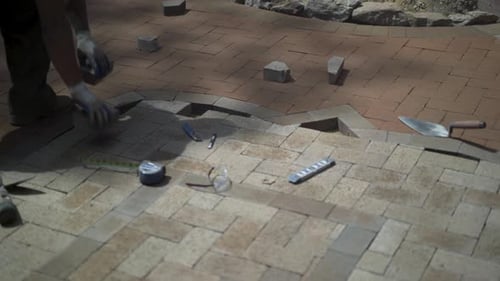 Man Sets Pavers for New Patio