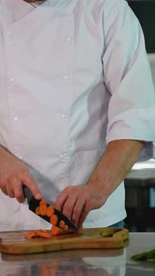 Chef Cuts Carrots in a Commercial Kitchen