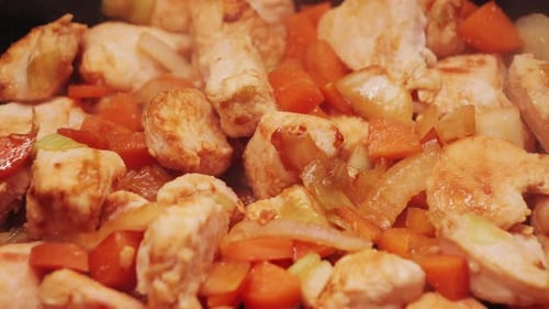 Chicken and Carrots Cooking in a Pan