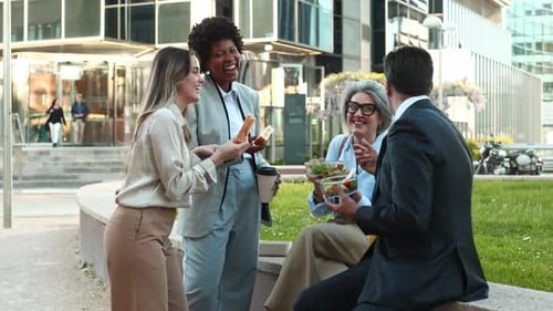 Colleagues Eating Lunch Together Outside Office Building