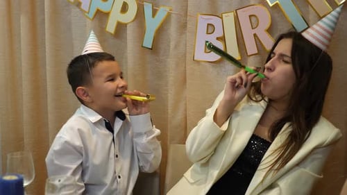 Birthday Celebration with Boy and Woman with Party Horns