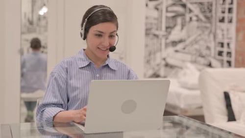 Young Indian Woman with Headset Talking with Customers Online in Call Center