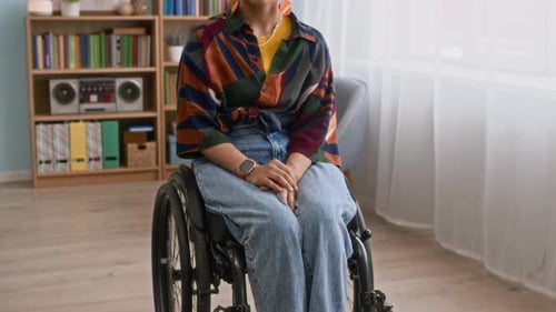 Young Woman in Wheelchair Sitting, Smiling