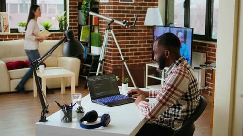 Man Works on Laptop from Home Office
