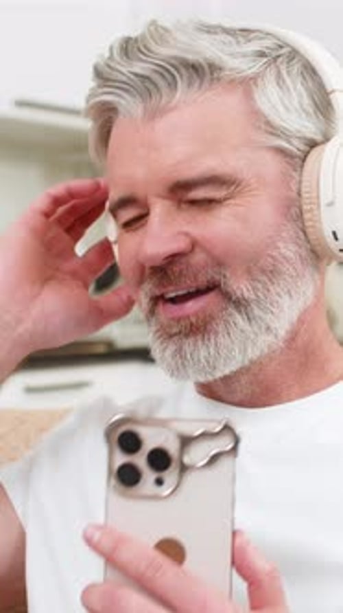 Man with headphones listens and dances to music