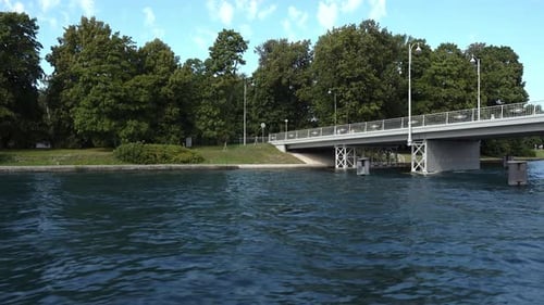 Sailing Along The River Along The Park And Bridge