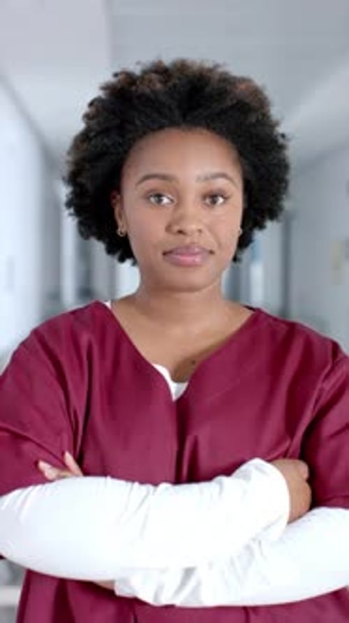 Smiling Healthcare Worker in Hospital Corridor