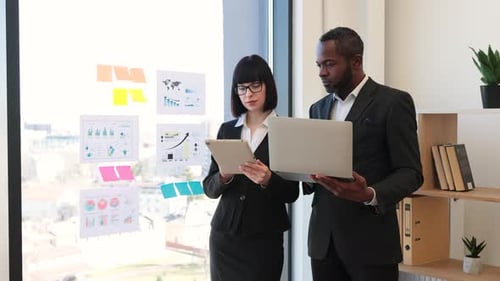 Business Professionals Analyzing Data Together in Modern Office