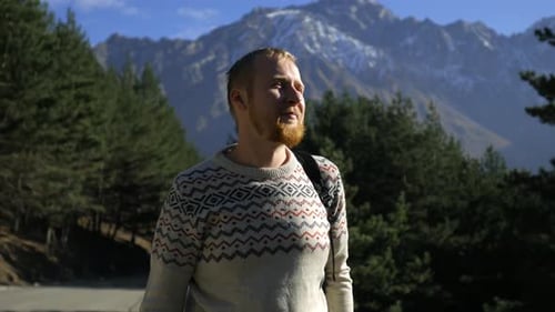 Man Enjoys Mountain View in Rural Forest
