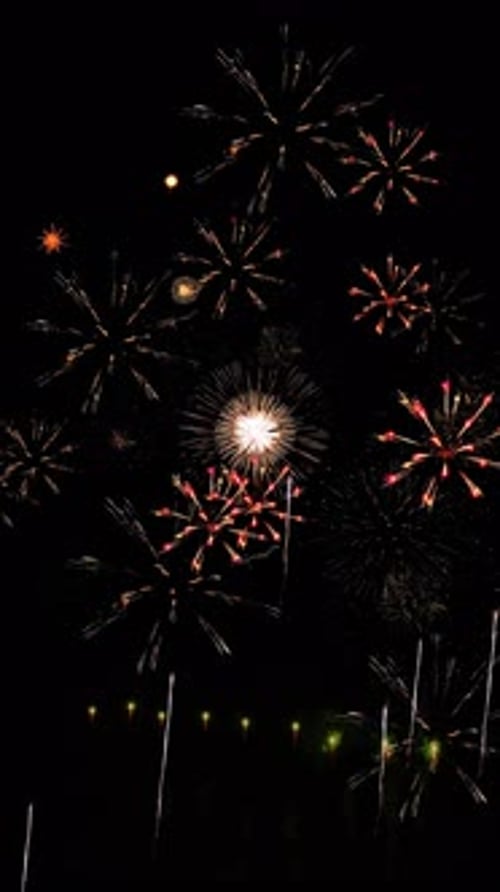 Real fireworks background bokeh lights in night sky. New year's eve fireworks celebration stars, par