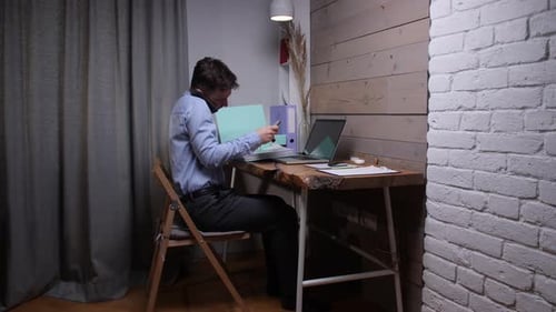 Man Working From Home Using Laptop and Tablet