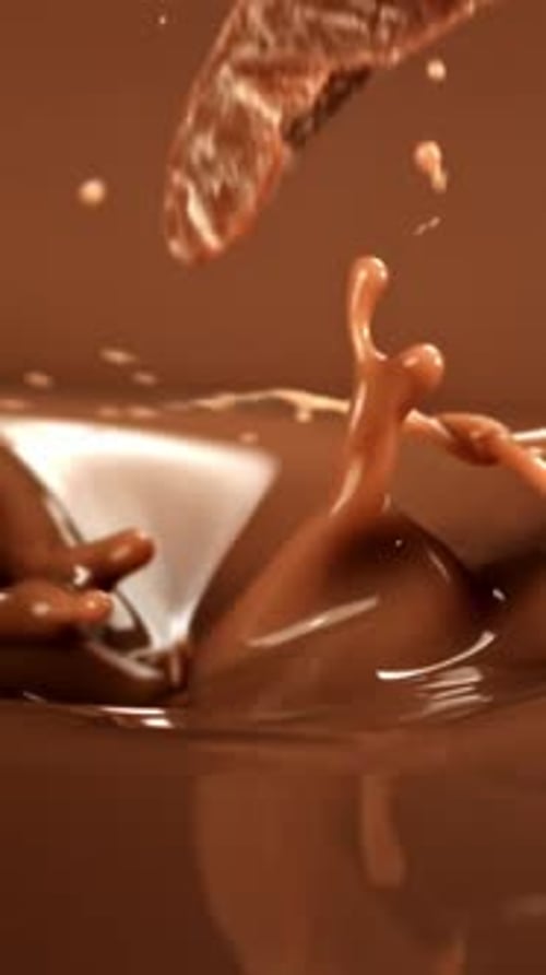 Super Slow Motion Dark Chocolate Chunks Fall Into Liquid Chocolate Filmed on a Highspeed Camera at