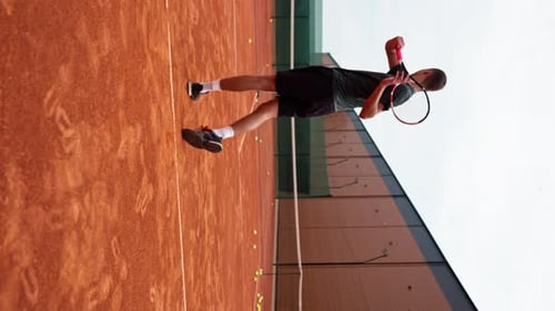 vertical video young professional player coach on outdoor tennis court practices strokes