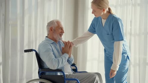 Caregiver in Hospital Helping an Elderly Patient for Support in Clinic Medical Nurse Talking to a