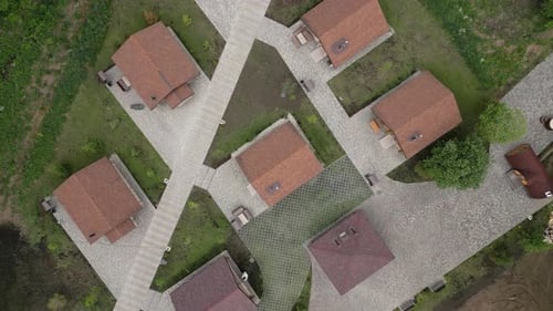 An Aerial View of Cozy Log Cabins Nestled Amidst Lush Greenery and Beautiful Landscapes Clip
