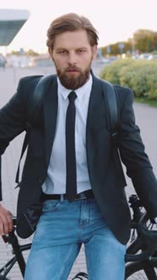 Portrait of Man in Black Jacket and Jeans Which Leaning on Personal Bicycle and Posing on Street