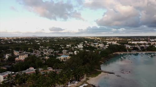Slow forward shot of holiday hotel area beside beach and port with boats