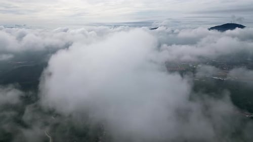 Aerial view fly over low cloud in rural
