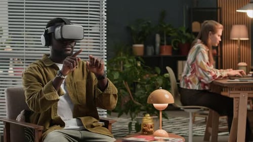 Young Developers Using Augmented Reality Glasses and Computers at IT Office