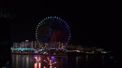Video about a giant wheel with a fireworks show in the city of Dubai United Arab Emirates