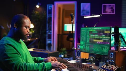 Sound Engineer Pressing Keys of Electronic Synthesizer and Composing New Song