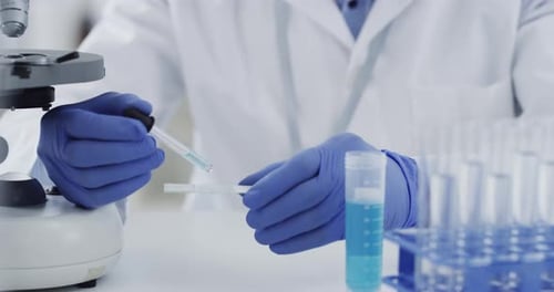 Scientist uses Pipette in Lab for Experiment