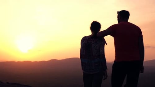 Couple Silhouette Watching Mountain Sunset Together