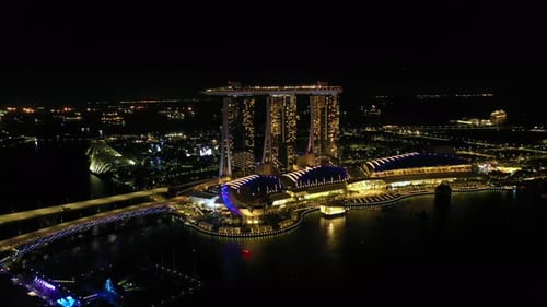 Drone Aerial view 4k Footage of the Marina Bay Sands in Singapore City Skyline. at night