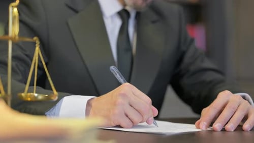 Close up of Male Judge Writing Verdict in Office