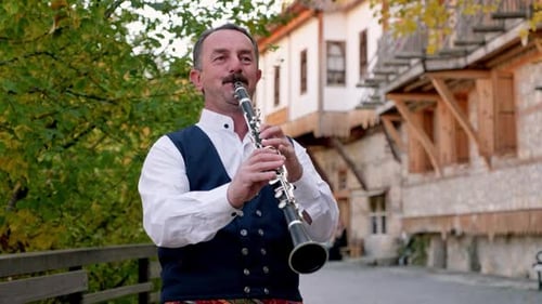 Man Playing a Clarinet on the Street