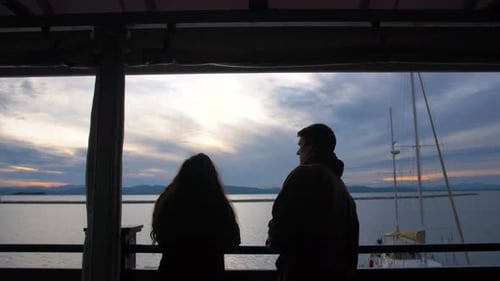 Couple enjoying a romantic sunset together in a small Vermont harbor town