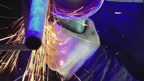 Professional Worker Works in Production with Metal