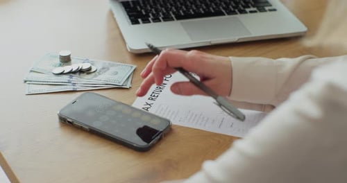 Close Up Woman Filling Tax Return Form
