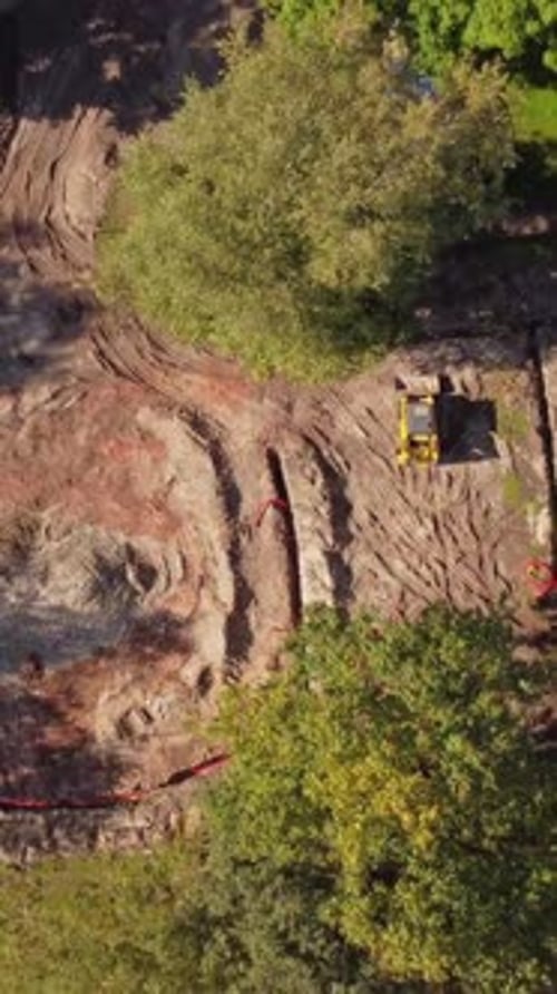 Riga Construction: Aerial View of Groundwork and Excavator on Site