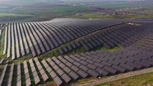 Aerial View of Solar Panel Farm on Green Hills