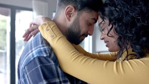 Loving Couple Embracing in a Romantic Indoor Setting