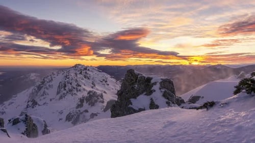 snowy and windy sunset in Navacerrada mountains, Madrid. Lenticular clouds at sunset.