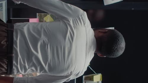 Adult Investigating Evidence on Detective Board