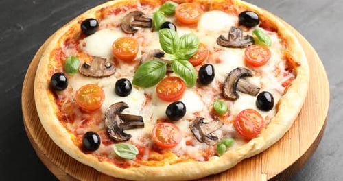 Freshly Baked Italian Pizza with Tomatoes Mushrooms and Black Olives