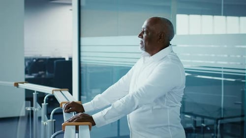 Mature Black Businessman Reflecting on Corporate Strategy in Office