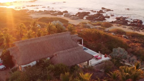 Sun rises as drone spins around beautiful waterfront luxury rental villas in Oaxaca Mexico. 4K aeria