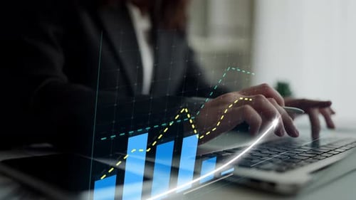 Business Professional Analyzing Financial Growth Trends on Laptop with Graphs and Charts in Modern O