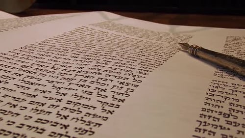 Yad Points to Hebrew in Torah on Bimah, Close Up