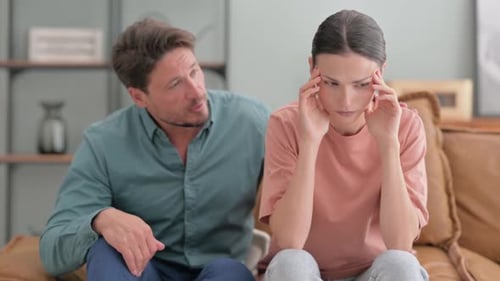 Upset Woman with Comforting Man in Home Setting
