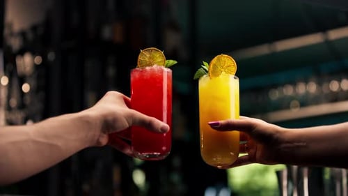 Close Up of Two People Cheering Cocktails in Bar or Disco Club Drinks and Cocktails Concept